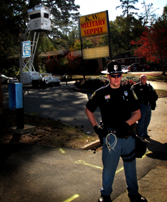 A local police officer guards Fort Benning from peaceful demonstrators